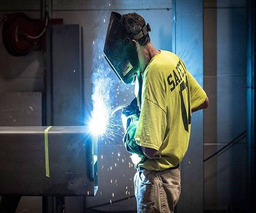 MCC Student welding with welding mask on