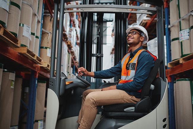 Facility employee driving a forklift