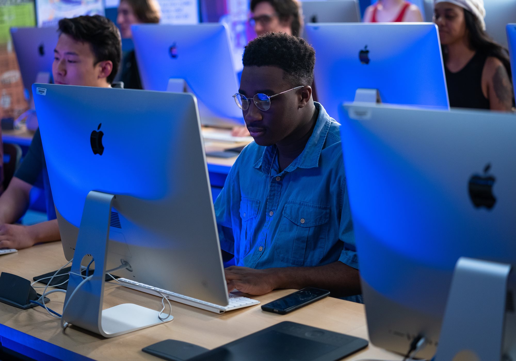 Male student looking at monitor