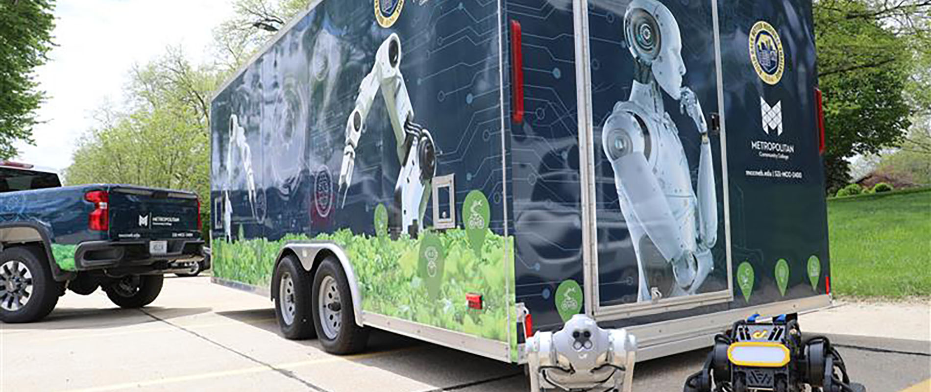 Metropolitan Community College Urban Agriculture and Robotics trailer with two robots on display in front of it