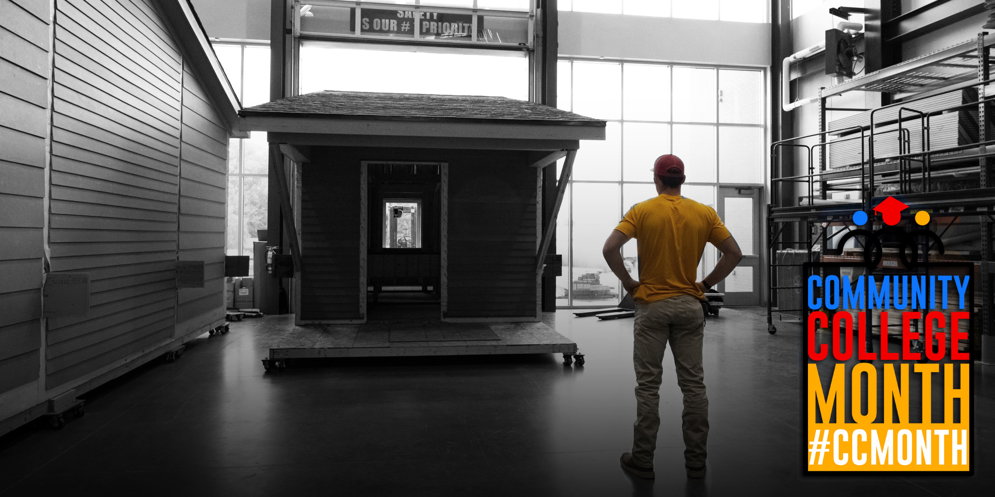 Student standing in front of a tiny house