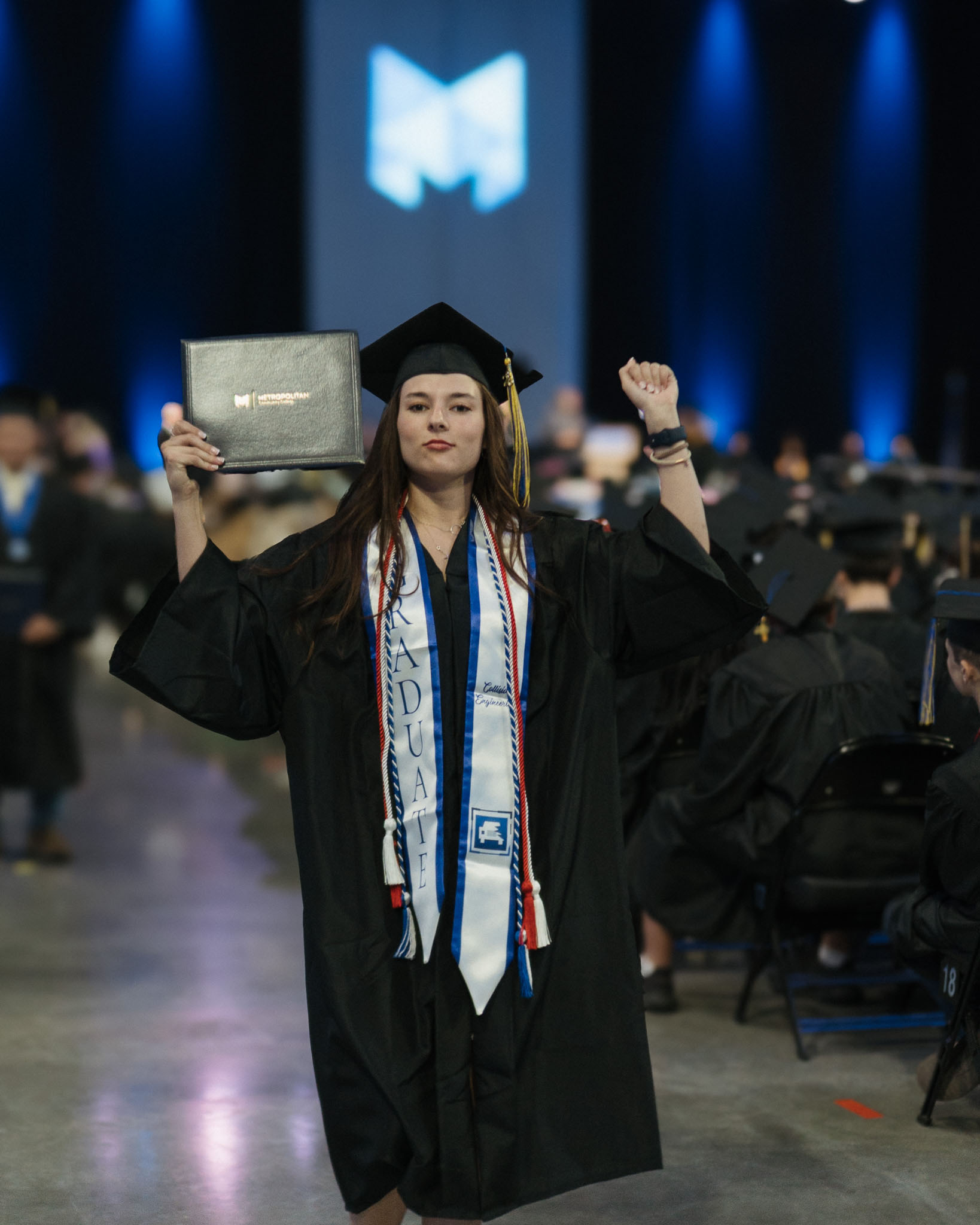 Female student posing with degree