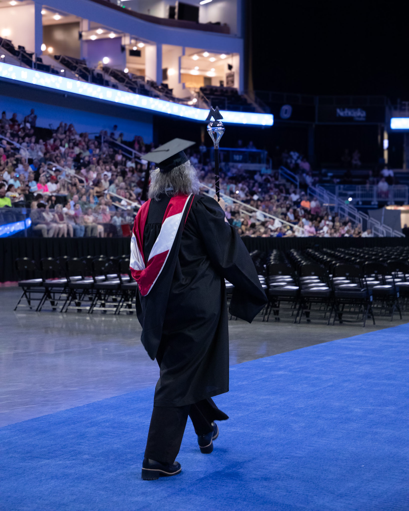 Faculty member walking into commencement ceremony hall