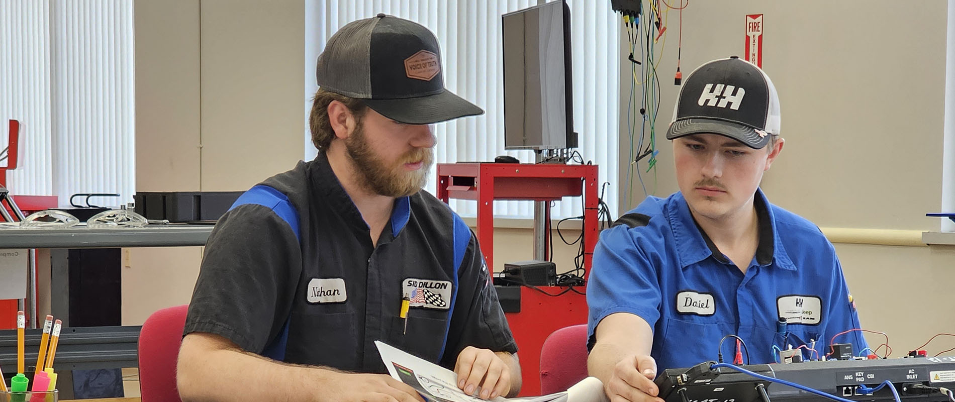 Two automotive students working on a tablet
