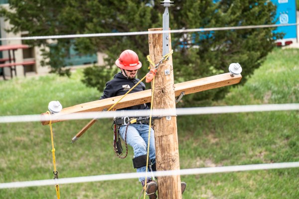 Photo of a person working on a power line during Linesman Rodeo in 2023