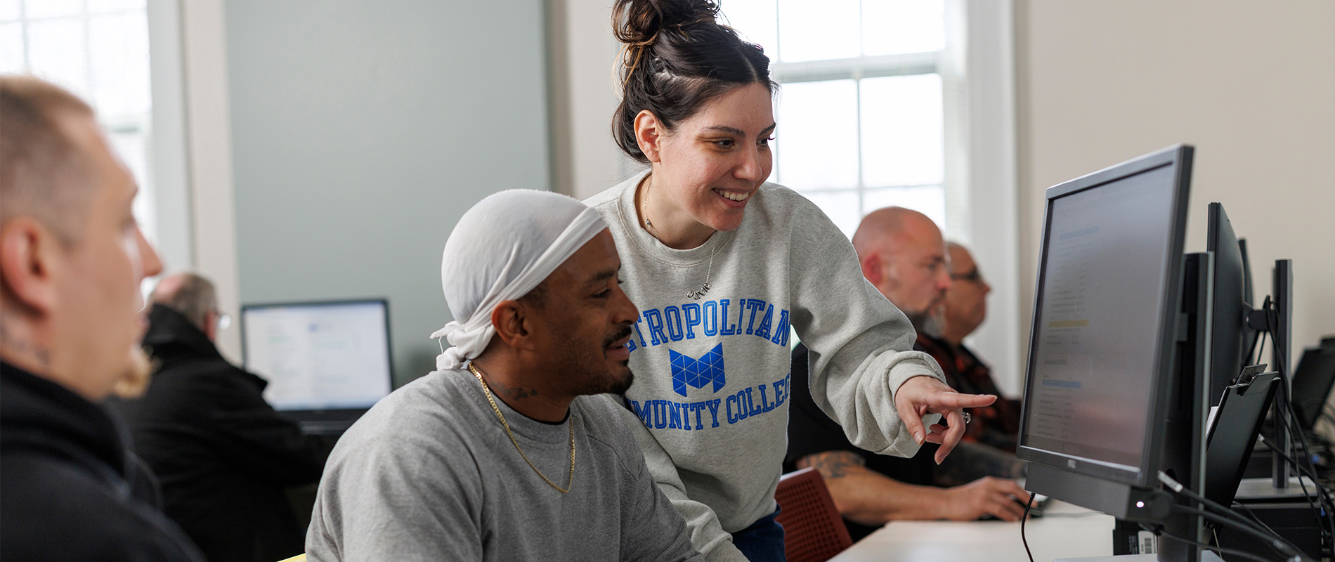 180 RAP staff member assisting program participants in the computer lab
