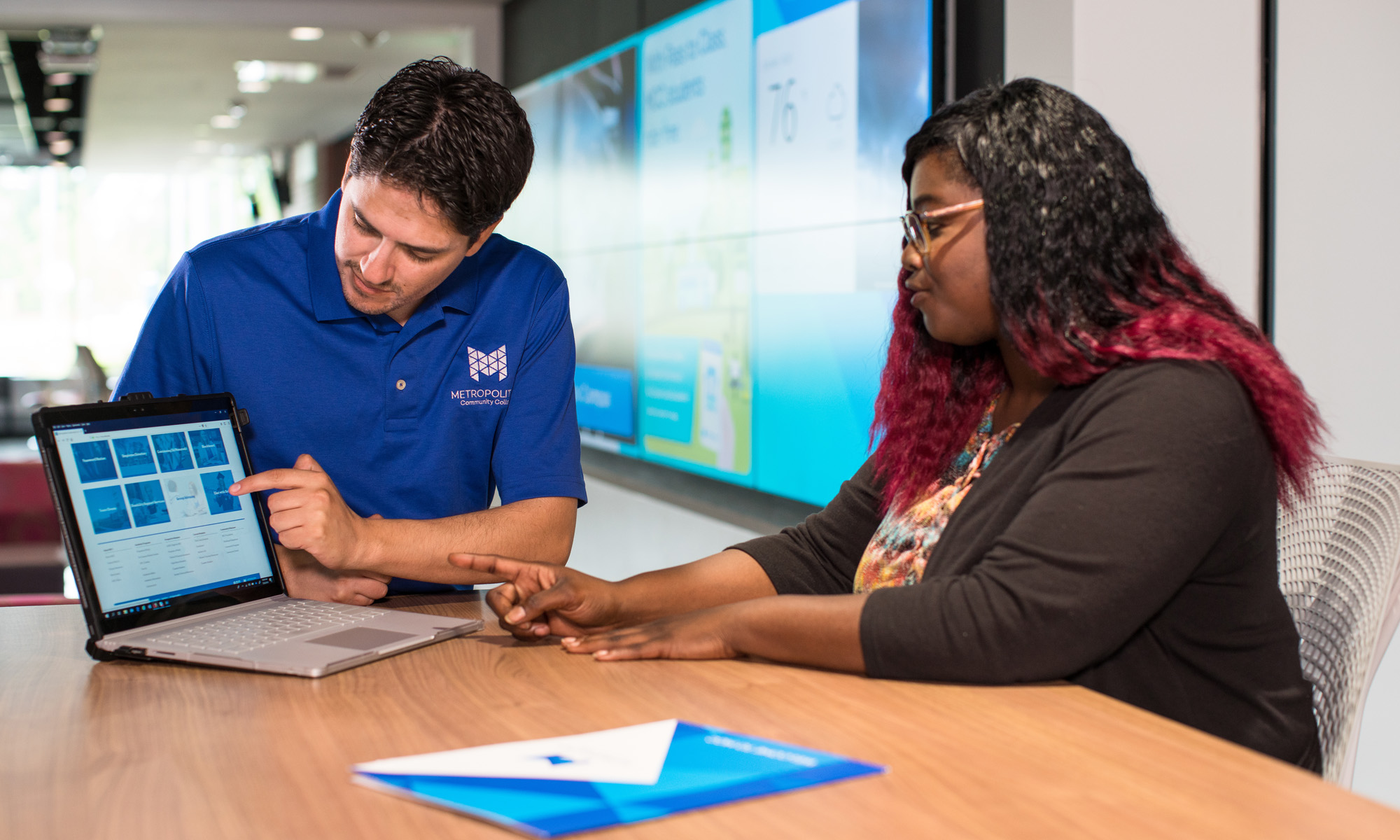 Female student working with advisor on laptop