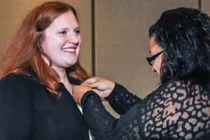 Two Females at nurses pinning ceremony. One receiving her min.