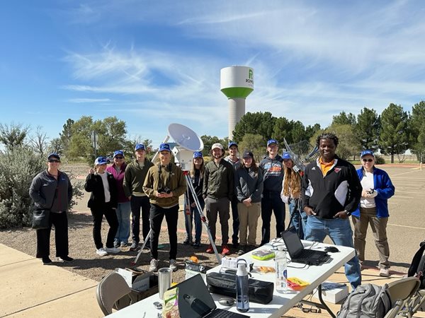 Students posing in front of equipment at high-altitude balloon launch preparation