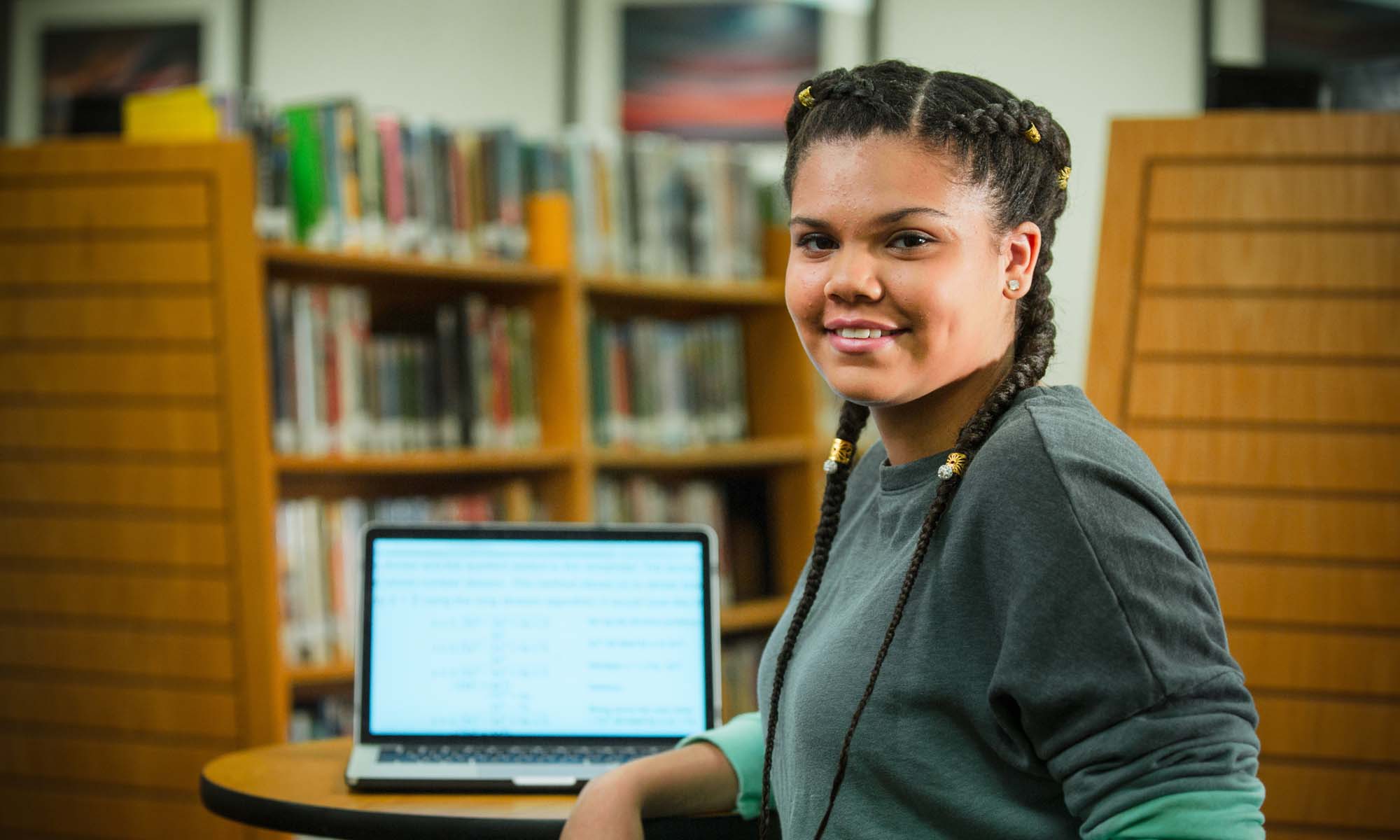 Happy student in college library