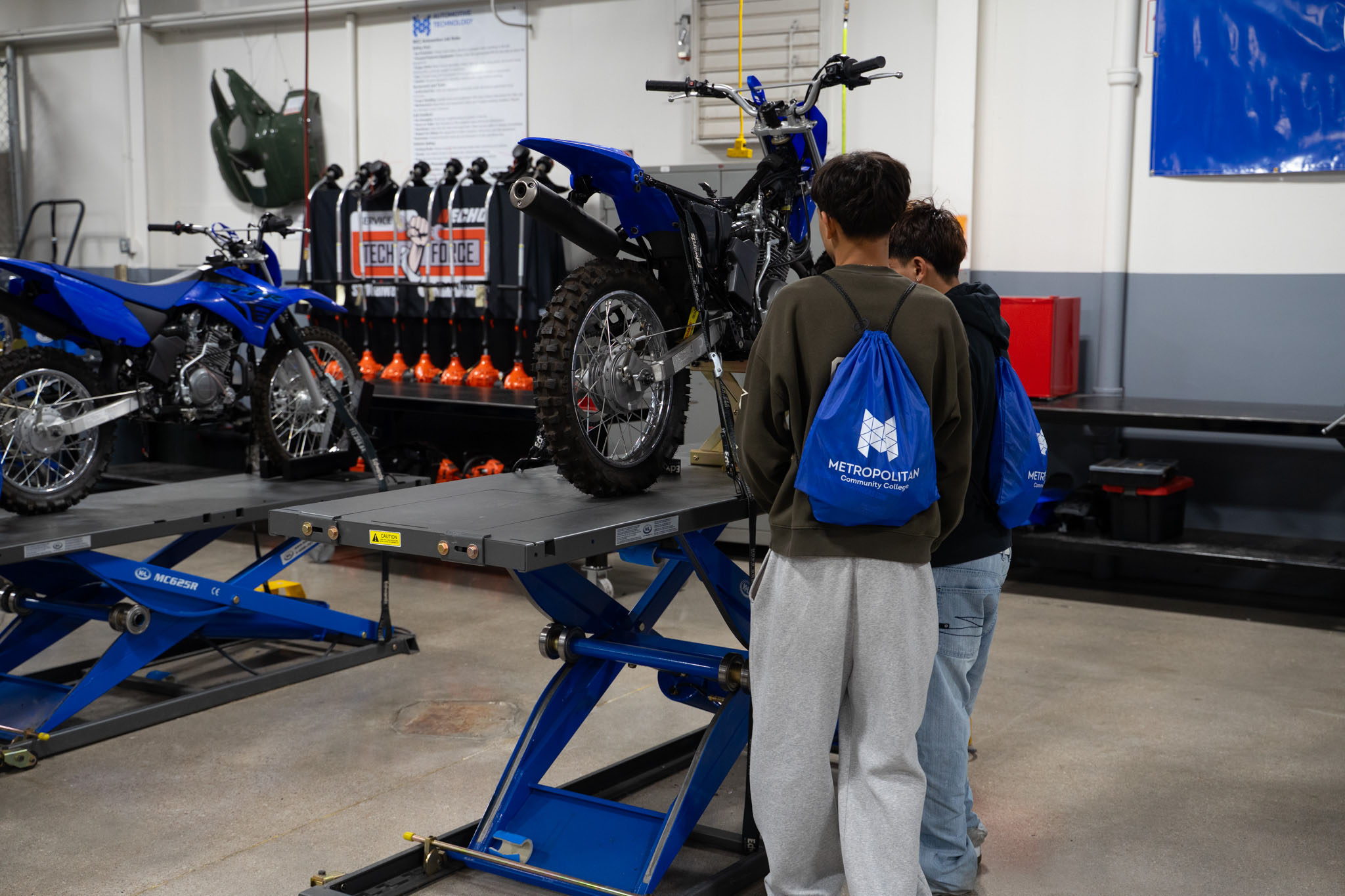 Students looking at a motorcycle