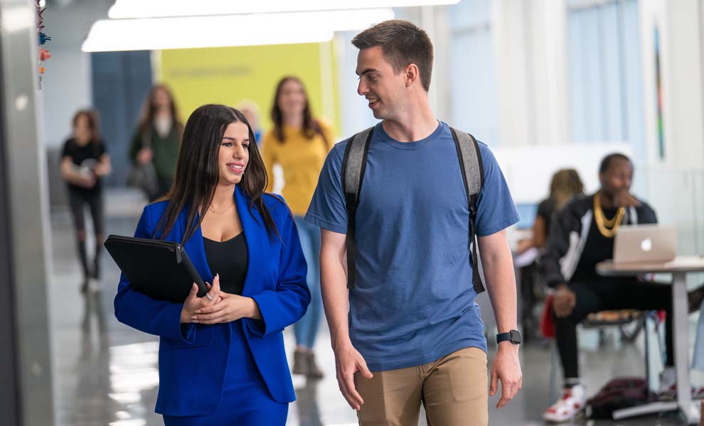 Happy-female-and-male-student-walking-to-class