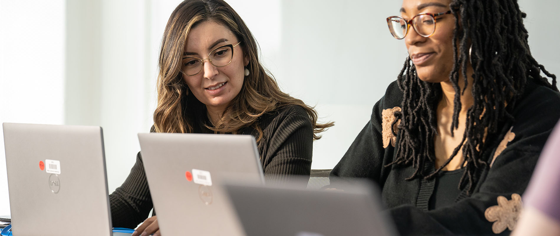 Two students working on a laptop